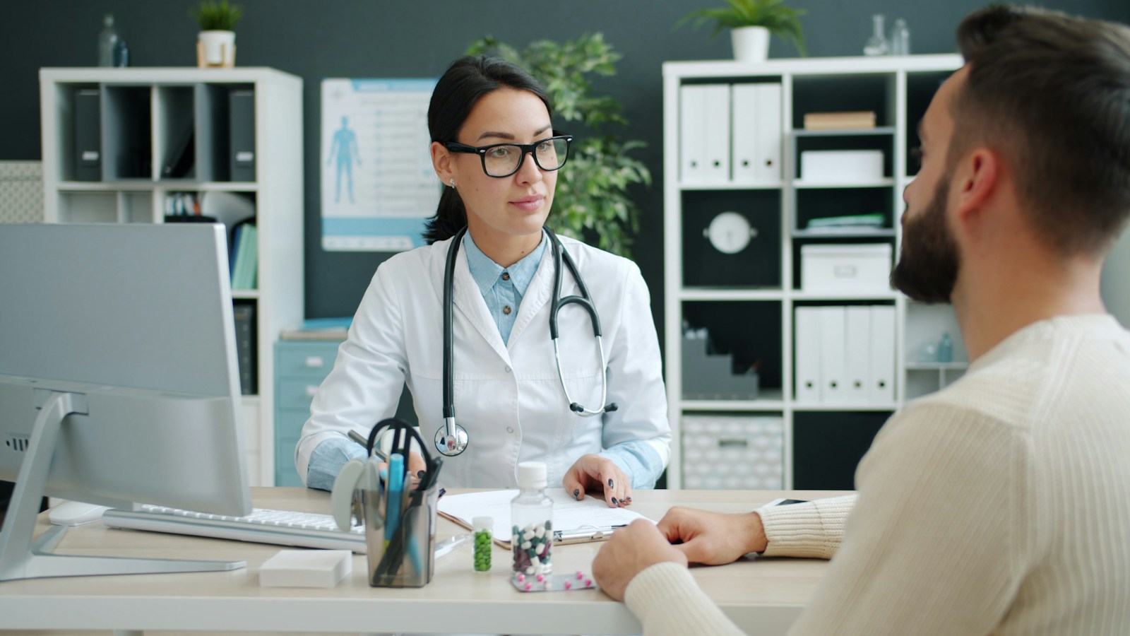 A healthcare professional listening to a patient during a consultation